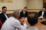 The Secretary for Labour and Welfare, Dr Law Chi-kwong, visited Yau Tsim Mong District and met with District Council members. Photo shows (from left) the Chairman of Yau Tsim Mong District Council, Mr Chris Ip; Dr Law; and the Under Secretary for Labour and Welfare, Mr Caspar Tsui, exchanging views with members on district matters.