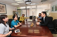 The Acting Secretary for Labour and Welfare, Mr Caspar Tsui, visited St James' Settlement (SJS) and sent his regards to personnel for their commitment during the passage of the typhoon for supporting members of the public and service users. Photo shows Mr Tsui (first right), accompanied by the Chief Executive Officer of SJS, Ms Josephine Lee (third right), listening to a domestic helper speaking on proactive visits or calls to elderly persons before the typhoon arrived to remind them of precautions at home.