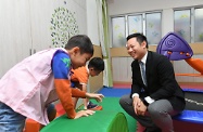 The Acting Secretary for Labour and Welfare, Mr Caspar Tsui, visited Causeway Bay Child Care Centre of St James' Settlement and sent his regards to personnel for their commitment during the passage of the typhoon for supporting members of the public and service users. Photo shows Mr Tsui (right) watching children playing in an activity room of the centre.