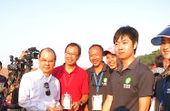 Mr Cheung (first left) is pictured with the visually impaired, volunteers and guide dogs in the Camp.