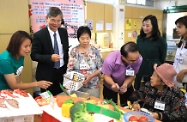 The Secretary for Labour and Welfare, Dr Law Chi-kwong, visited the Yang Memorial Methodist Social Service Senior Citizen Cognitive Training Centre to better understand the operation of a recognised service provider of the Second Phase of the Pilot Scheme on Community Care Service Voucher for the Elderly. Picture shows Dr Law (second left), accompanied by the Assistant Director (Elderly and Youth) of Yang Memorial Methodist Social Service, Ms Joyce Lee (back row, second right), observing elderly people participating in a Cognitive Stimulating Training Group.