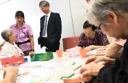 The Secretary for Labour and Welfare, Dr Law Chi-kwong, visited the Yang Memorial Methodist Social Service Senior Citizen Cognitive Training Centre. Picture shows Dr Law (third left) observing elderly people participating in Individual Training.