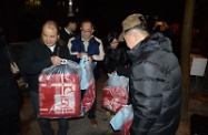 Mr Cheung (first left) distributing blankets to street sleepers.