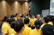 Mr Cheung chats with the home-carers and volunteers of the Programme and encourages them to apply what they learnt to support those in need in the community.