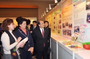 Mr Cheung (third left) and Ms Chen Zhili (second left) tour an exhibition on the Funding Scheme for Women's Development under the Women's Commission.