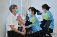 The Secretary for Labour and Welfare, Dr Law Chi-kwong (left), receives COVID-19 vaccination today (February 22) at the Community Vaccination Centre at the Hong Kong Central Library Exhibition Gallery.