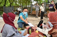 The Secretary for the Civil Service, Mr Patrick Nip, distributes leaflets at Victoria Park today (August 1) to encourage people from ethnic minorities in Hong Kong to get vaccinated against COVID-19.