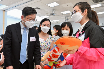 The Secretary for Labour and Welfare, Mr Chris Sun; the Permanent Secretary for Labour and Welfare, Ms Alice Lau; and the Director of Social Welfare, Miss Charmaine Lee, visited Po Leung Kuk Wai Yin Kindergarten-Cum-Nursery this morning (August 23) to learn more about the effectiveness and implementation of the On-site Pre-school Rehabilitation Services. Photo shows (from left) Mr Sun, Ms Lau and Miss Lee being briefed by a staff member of the school on its learning materials.