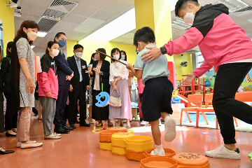 The Secretary for Labour and Welfare, Mr Chris Sun; the Permanent Secretary for Labour and Welfare, Ms Alice Lau; and the Director of Social Welfare, Miss Charmaine Lee, visited Po Leung Kuk Wai Yin Kindergarten-Cum-Nursery this morning (August 23) to learn more about the effectiveness and implementation of the On-site Pre-school Rehabilitation Services. Photo shows Mr Sun (fourth left) and Miss Lee (sixth left) watching a child receiving balance training in the activity zone.