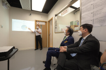 The Secretary for Labour and Welfare, Mr Chris Sun, visited the service centre of Blue Sky Short-term Food Assistance Service Team of Po Leung Kuk (PLK) in Yuen Long this afternoon (August 30) to take a closer look at the latest situation after its regularisation from August 2021. The Director of Social Welfare, Miss Charmaine Lee, also joined the visit. Photo shows (from right) Mr Sun and the Chairman of PLK, Dr Daniel Chan, being briefed by a centre staff member on the major categories of cases in the district and their needs.