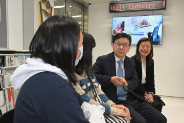 The Secretary for Labour and Welfare, Mr Chris Sun, today (March 1) visited the Recruitment Centre for the Catering Industry and the Recruitment Centre for the Retail Industry at the Treasury Building in Cheung Sha Wan to take a closer look at the enhanced employment services of the Labour Department upon resumption of economic activities following the lifting of all mandatory mask-wearing requirements in Hong Kong. The Commissioner for Labour, Ms May Chan, also joined the visit. Photo shows Mr Sun (second right) and Ms Chan (first right) listening to job seekers sharing their job searching experiences.