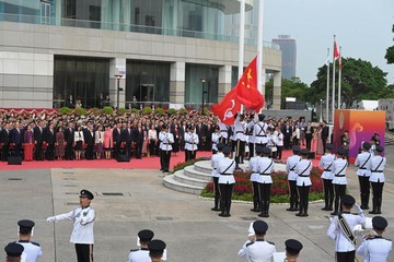 The Chief Executive, Mr John Lee, together with Principal Officials and guests, attends the flag-raising ceremony for the 74th anniversary of the founding of the People's Republic of China at Golden Bauhinia Square in Wan Chai this morning (October 1).