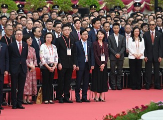The Chief Executive, Mr John Lee, together with Principal Officials and guests, attends the flag-raising ceremony for the 74th anniversary of the founding of the People's Republic of China at Golden Bauhinia Square in Wan Chai this morning (October 1). Photo shows the Secretary for Labour and Welfare, Mr Chris Sun (front row, second right).