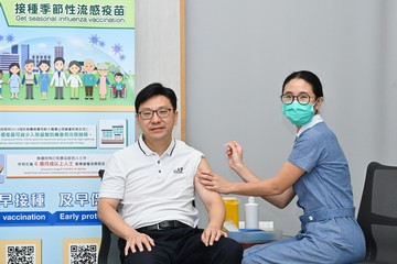 The Secretary for Labour and Welfare, Mr Chris Sun (left), also got vaccinated.