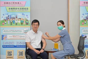 The Under Secretary for Labour and Welfare, Mr Ho Kai-ming (left), also got vaccinated.