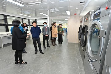 The Secretary for Labour and Welfare, Mr Chris Sun, visited the Siu Lam Integrated Rehabilitation Services Complex this afternoon (January 24) to keep abreast of the various rehabilitation services which commenced operation in phases from December 2023. Photo shows Mr Sun (front row, second left) being briefed on the laundry training for persons with disabilities in his visit to the Greenery Vocational Rehabilitation Centre, an Integrated Vocational Rehabilitation Services Centre.