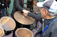 Mr Cheung chats with elderly band players in the centre and encourages them to develop interests and participate more in community activities.
