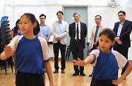 The Secretary for Labour and Welfare, Dr Law Chi-kwong, visited Kowloon City District and called at Po Leung Kuk Madam Chan Wai Chow Memorial School. Photo shows (back row, from second left) the Vice Chairman of Kowloon City District Council (KCDC), Mr Cho Wui-hung; the Chairman of KCDC, Mr Pun Kwok-wah; Dr Law; the Principal of the school, Mr Chan Kin-hung; and the District Officer (Kowloon City), Mr Franco Kwok, watching pupils doing rehearsals for their graduation ceremony.
