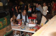 Mr Cheung (first left) plays games with some young night drifters in Tin Shui Wai in the early hours of this morning.