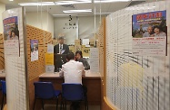 The Secretary for Labour and Welfare, Dr Law Chi-kwong, visited the Social Security Field Unit (Guangdong Scheme) of the Social Welfare Department. Photo shows Dr Law (first left) observing a demonstration on the process of application for the Old Age Allowance under the Guangdong Scheme.