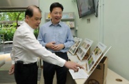 Mr Cheung (left) is briefed on the various barrier-free improvement works in Hung Hom Estate.