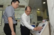 Mr Cheung (right) inspects the Braille and Tactile Floor Plan/Directory Map installed for the visually impaired at the Hung Hom Municipal Services Building.