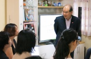 Mr Cheung chats with a social worker and girls who reside at the Home Care for Girls to better understand their daily life.