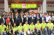Mr Cheung (fifth right, middle row) is pictured with other officiating guests and staff of the HOME Market at the opening ceremony.