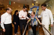 The Chief Executive, Mr C Y Leung, and the Secretary for Labour and Welfare, Mr Matthew Cheung Kin-chung, visited the Po Leung Kuk Sai Ying Pun Home for the Elderly cum Day Care Centre to better understand its operation. Picture shows Mr Leung (third right) and Mr Cheung (first left) chatting with an elderly person during her physiotherapy session.