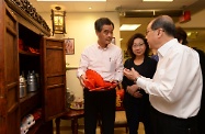 Mr Cheung (right) introduces to Mr Leung (left) a retro item used by the centre to strengthen elderly persons' cognitive ability through encouraging them to reminisce about the past.