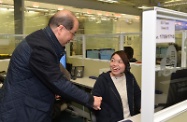 Mr Cheung (left) visits the 24-hour Call and Care Centre of the Senior Citizen Home Safety Association and thanks the staff for their dedication and professionalism during the cold weather.