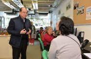 Mr Cheung (first left) chats with the elderly volunteers at the Call and Care Centre and congratulates them for realising the concept of "active ageing" through caring for elderly persons in need.