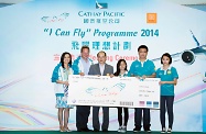 At the pledging ceremony of the 6th Cathay Pacific “I Can Fly” Programme, the Secretary for Labour and Welfare, Mr Matthew Cheung Kin-chung (third left), accompanied by the Chief Operating Officer of Cathay Pacific, Mr Rupert Hogg (second left), and the Director Corporate Affairs, Ms Chitty Cheung (first left), present to the participating members a boarding pass which signifies the launch of the Programme and the take-off of their flying path.
