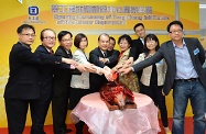 The guests perform the roasted pig carving ceremony for the official opening of the job cent.