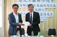 The Secretary for Labour and Welfare, Dr Law Chi-kwong (right), paid a courtesy visit to the Hong Kong and Kowloon Trades Union Council (TUC). Picture shows the Chairman of TUC, Mr Lo Tai-chi (left) submitting a petition letter to Dr Law.