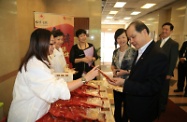 The Secretary for Labour and Welfare, Mr Matthew Cheung Kin-chung (first right), visited the Yan Chai Hospital (YCH) Healthy Herbal Packs Centre, where he was briefed by the Vice-Chairman of the YCH Board of Directors, Mrs Susan So (second right), on the Centre's self-reliance scheme.