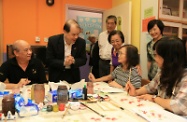 Mr Cheung (second left) observes elderly people taking part in a drawing class at the YCH Fong Yock Yee Neighbourhood Elderly Centre.
