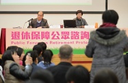 Mr Cheung (left) and Mrs Lam (right) listen to public views at the forum.