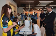 The Secretary for Labour and Welfare, Dr Law Chi-kwong, visited North District and called at the Ellen Li District Elderly Community Centre of the Hong Kong Young Women's Christian Association. Photo shows Dr Law (first right) viewing how volunteers conduct checks for elderly persons using Automatic Retinal Image Analysis System to test for the risk of stroke.