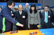 Mr Cheung (second left) visits the Vocational Training Council's booth with the Hong Kong Trade Development Council's Executive Director, Ms Margaret Fong (second right), and Deputy Executive Director Mr Benjamin Chau (first right).