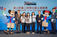 The Secretary for Labour and Welfare, Mr Matthew Cheung Kin-chung (third right), presents merit certificate to three outstanding volunteers of Disney VoluntEARS in recognition of their remarkable contribution to volunteering work.