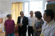 Mr Cheung (second left) and Mr Fung (centre) tour the first Hong Kong-run elderly care home under the Mainland and Hong Kong Closer Economic Partnership Arrangement in the Yuexiu District of Guangzhou, where they were briefed by the operators on its services.