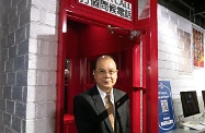 The Secretary for Labour and Welfare, Mr Matthew Cheung Kin-chung, visited the headquarters of the Senior Citizen Home Safety Association to familiarise himself with the Association's support and care services for the elderly. Picture shows Mr Cheung touring a telephone booth facility which aims to foster inter-generational harmony by encouraging youngsters to care more about the elderly by calling them on the telephone.