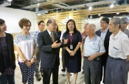 Mr Cheung (fourth left) chats with elderly participants of a photography class and shares with them the concept of active ageing.