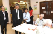 The Secretary for Labour and Welfare, Dr Law Chi-kwong, called at Chi Lin Care and Attention Home (C&AH) and Chi Lin Day Care Centre for the Elderly and visited elderly persons. Photo shows (from left) the Acting Superintendent of the C&AH, Mr Cain Ng; Dr Law; and the Member of Chi Lin Elderly Service Committee, Mrs Sophie Leung, greeting elderly persons.