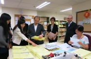 Mr Cheung (fourth right) tours different office units of the Division to understand the procedures of handling WITS applications.