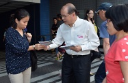 Mr Cheung (centre) distributes leaflets to the public.