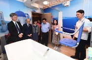 The Secretary for Labour and Welfare, Dr Law Chi-kwong, visited Po Leung Kuk Wan Chai Home for the Elderly cum Day Care Centre for the Elderly. Photo shows Dr Law (first left), accompanied by the Chairman of the Wan Chai District Council, Mr Stephen Ng (third right), and the Chairman of the Board of Directors of Po Leung Kuk, Mr Ma Ching-nam (second left), touring therapeutic bathing facilities at the centre.