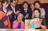 The wife of President Xi Jinping, Peng Liyuan (front row, right), shows her appreciation to an elderly lady in making a pop-up card during her visit to TWGHs Jockey Club Sunshine Complex for the Elderly in Wong Chuk Hang. Those joining her in the visit include Deputy Director of the Liaison Office of the Central People's Government in the Hong Kong Special Administrative Region, Ms Yin Xiaojing (second, first right); the Secretary for Labour and Welfare, Mr Stephen Sui (second row, second right); and the Chairman of the Tung Wah Group of Hospitals, Dr Lee Yuk-lun (second row, second left).
