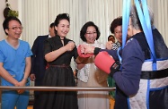 The wife of President Xi Jinping, Peng Liyuan (second left), gives encouragement to an elderly person receiving therapeutic training during her visit at TWGHs Jockey Club Sunshine Complex for the Elderly in Wong Chuk Hang. Looking on are the wife of the Chief Executive, Mrs Regina Leung (third left); and Deputy Director of the Liaison Office of the Central People's Government in the Hong Kong Special Administrative Region Ms Yin Xiaojing (fourth left).
